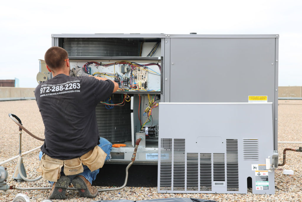 HVAC Technician performing air conditioner service
