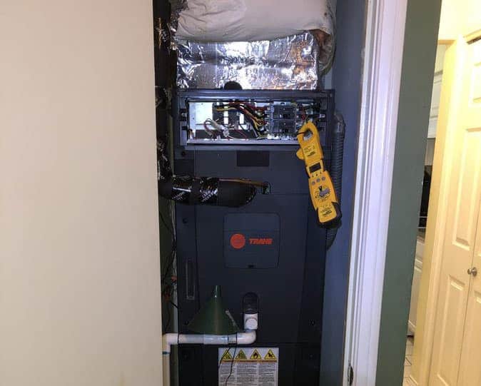 Preventive maintenance on a furnace by a heating technician