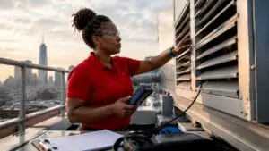 Engineer inspecting fresh air intake louvers on rooftop