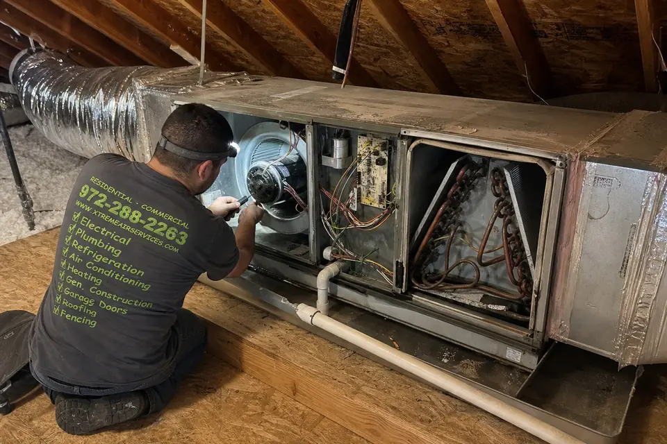 Air handler installation, Sunnyvale, TX Cutaway of a horizontal attic air handler showing its blower motor, capacitor and coil as an Xtreme Air Services technician works on it, Sunnyvale, TX