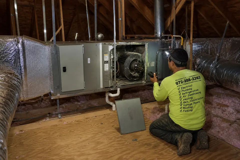 Signs your blower motor is failing, Sunnyvale, TX Xtreme Air Services technician examining a worn squirrel-cage blower in a suspended attic furnace and air handler, Sunnyvale, TX