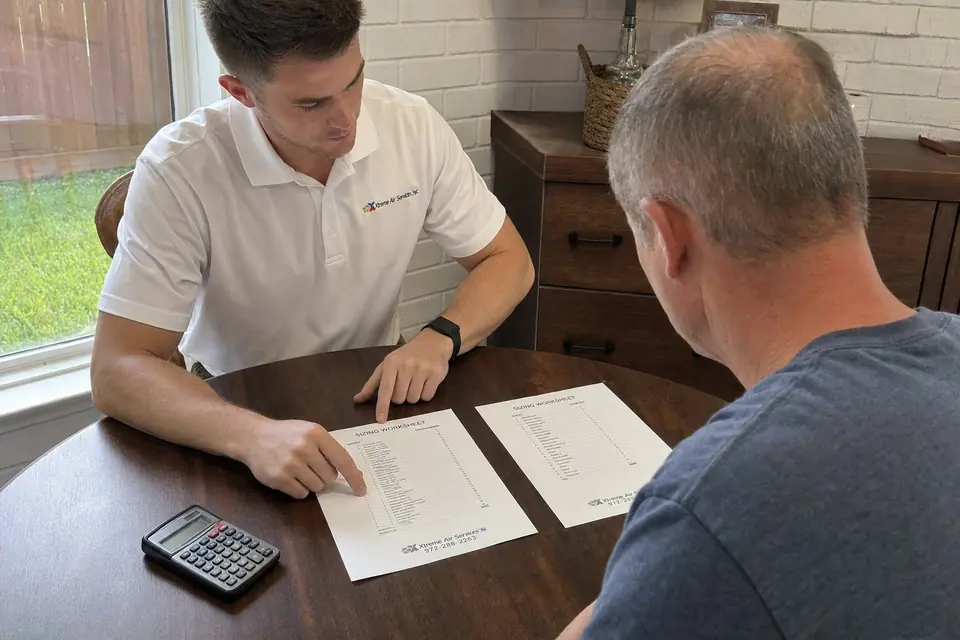Xtreme Air Services representative comparing whole-home and essential-circuits generator sizing worksheets with a Sunnyvale, TX homeowner